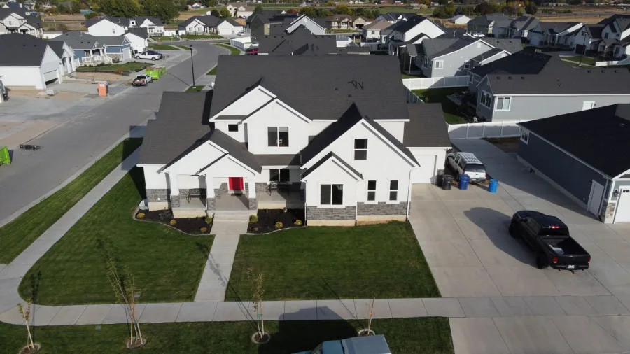 Spring - Aerial view of a modern suburban home in Spanish Fork, Utah, showcasing a neat neighborhood layout